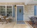 Inviting front porch with decor and stylish blue door, perfect for enjoying outdoor living at 2214 Olde Chantilly Ct, Charlotte, NC 28205