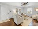 Bright living room with hardwood floors, shiplap walls, and a comfortable seating arrangement at 2843 Cowles Rd, Charlotte, NC 28208