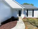Inviting home entrance featuring a well-kept lawn and easy access walkway to the front door at 3007 Walsingham Ct, Matthews, NC 28105