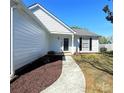 Inviting home entrance featuring a well-kept lawn and easy access walkway to the front door at 3007 Walsingham Ct, Matthews, NC 28105