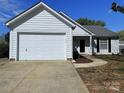 Charming single-story home with an attached two-car garage and a well-manicured front yard, perfect for curb appeal at 3007 Walsingham Ct, Matthews, NC 28105