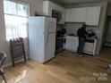 Bright kitchen with white cabinets, modern appliances, and hardwood flooring at 301 Huffman Rd, Gastonia, NC 28056