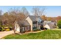 Aerial view of a two-story home with lush landscaping, a large yard, and an attached garage at 3765 11Th Ne St, Hickory, NC 28601