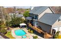 Aerial view of backyard with a refreshing pool, hot tub, gazebo, and spacious wooden deck at 3765 11Th Ne St, Hickory, NC 28601
