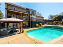 Large backyard features a refreshing pool, a lounge area with a gazebo, and a spacious deck at 3765 11Th Ne St, Hickory, NC 28601