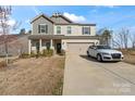 Charming two-story home featuring a well-maintained lawn, a two-car garage, and neutral-colored siding at 4104 Armstrong Farm Dr, Belmont, NC 28012