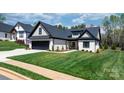 Charming single-story home featuring a well-manicured lawn, brick facade, and a paved walkway leading to the entrance at 4210 Holly Ne Cir, Conover, NC 28613