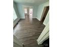 A spacious living room with freshly painted light blue walls and wood flooring at 4510 Wildwood Ave, Charlotte, NC 28208