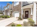 Charming front entrance with a decorative wreath on the door, stone accents, and manicured landscaping at 4644 Craigmoss Ln, Charlotte, NC 28278