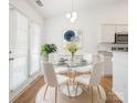 Bright dining area featuring a modern chandelier, glass table, and french doors at 5291 Moonlight Sw Trl, Concord, NC 28025