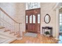 Elegant entryway showcasing a stunning front door with glass panes and light hardwood floors at 5419 Sunningdale Dr, Charlotte, NC 28277