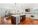 Spacious kitchen with an island, stainless steel appliances, and an open dining area with lots of natural light at 552 Odell School Rd, Concord, NC 28027