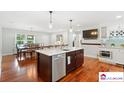 A spacious kitchen area with a large island, white countertops, and stainless steel appliances at 552 Odell School Rd, Concord, NC 28027