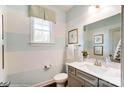 Cozy powder room features blue and white striped walls and a vanity with a framed mirror at 6250 Tea Olive Dr # 240, Harrisburg, NC 28075