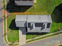 Bird's eye view of home featuring a roof with solar panels, lush yard, and long driveway at 6308 Brumit Ln, Charlotte, NC 28269