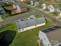 Aerial view of roof and surrounding neighborhood with well-maintained lawns and clear blue sky at 6308 Brumit Ln, Charlotte, NC 28269