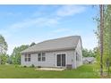 The backyard features an easy to maintain lawn with a small patio at 700 Sunset Pointe Dr, Salisbury, NC 28146