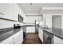 Modern kitchen with stainless steel appliances, granite countertops, and white cabinetry at 700 Sunset Pointe Dr, Salisbury, NC 28146