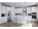 Modern white kitchen with stainless steel appliances, island seating, and pendant lighting at 7027 Short Stirrup Ln, Mint Hill, NC 28227