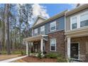 Attractive townhome boasting a stone facade, blue siding, and covered entrance at 7918 Nelson Rd, Mint Hill, NC 92227