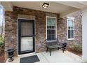 Cozy front porch with stone accents, bench seating, and a secure entrance at 7918 Nelson Rd, Mint Hill, NC 92227