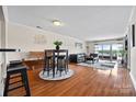 Open-concept living room with hardwood floors, stylish furnishings, and access to a private balcony at 9709 Emerald Point Dr # 6, Charlotte, NC 28278
