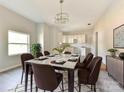 Elegant dining room with a stylish chandelier, seating for eight, and a view to the kitchen at 108 Graham St, Chester, SC 29706