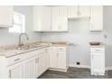 Bright kitchen with stainless steel sink, white cabinets, and light-colored countertops at 108 Graham St, Chester, SC 29706