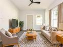 Cozy living room with a modern ceiling fan, neutral tones, and stylish furnishings at 108 Graham St, Chester, SC 29706