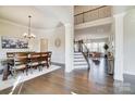 Elegant foyer with soaring ceilings, hardwood floors, dining room, stairway and open view to the living room at 11144 Limehurst Pl, Charlotte, NC 28278