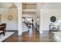 Bright foyer featuring hardwood floors, grand stairway, elegant decor and providing an open transition to the living space at 11144 Limehurst Pl, Charlotte, NC 28278