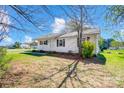 A charming single-story home with neutral siding nestled on a well-maintained lawn and mature trees at 130 Atwell Rd, Mt Ulla, NC 28125
