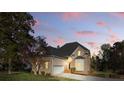 Charming brick home featuring a two-car garage, bay window, and lush landscaping at 13833 Jonathans Ridge Rd, Mint Hill, NC 28227