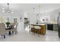 Bright eat-in kitchen with quartz countertops, wooden island, and modern appliances at 13833 Jonathans Ridge Rd, Mint Hill, NC 28227