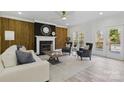 Bright living room with fireplace, wood accent wall, and neutral decor at 13833 Jonathans Ridge Rd, Mint Hill, NC 28227