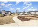 Landscaped community space with benches, walkways, and well-kept lawns at 15616 Parkside Crossing Dr, Charlotte, NC 28278