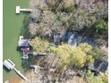 Aerial view of waterfront property with mature trees, private dock, and boat slip offering stunning views at 1657 Bowater Rd, Rock Hill, SC 29732