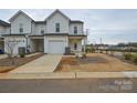 Charming townhouse featuring a one car garage and inviting covered porch at 1814 Saint Louis Nw Aly, Concord, NC 28027