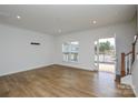 Well lit living room featuring a sliding glass door and hardwood floors at 1814 Saint Louis Nw Aly, Concord, NC 28027
