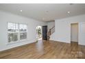 Bright living room with hardwood floors and large windows at 1814 Saint Louis Nw Aly, Concord, NC 28027