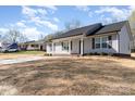 A charming, light-gray house with a well-manicured lawn and concrete driveway on a clear, sunny day at 206 W 19Th St, Kannapolis, NC 28081