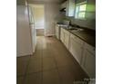 Functional kitchen with white cabinets, efficient appliances, and ample counter space at 2312 Tate St, Charlotte, NC 28216