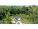 Overhead view of a single-story home with green trees, surrounded by a yard at 253 Artemis Pl # 27, Kershaw, SC 29067