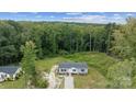 Aerial view of a well-maintained single-story home surrounded by lush, mature trees at 253 Artemis Pl # 27, Kershaw, SC 29067
