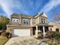 Inviting home with brick and siding exterior, attached two-car garage, and a charming front porch at 2741 Smethwick Ln, Gastonia, NC 28056