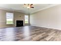 Spacious living room with hardwood floors, a fireplace, and large windows at 2776 Ashton Park Ln # 12, Monroe, NC 28110