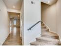 Inviting foyer with a staircase leading to the upper level, and hardwood flooring at 319 Pond Place Ln, Matthews, NC 28104