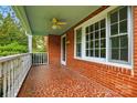 Inviting brick porch with a decorative tile floor and a ceiling fan at 3221 Cosby Pl, Charlotte, NC 28205