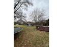 Wide shot of the backyard featuring a trampoline and an above-ground pool at 3260 Reepsville Rd, Lincolnton, NC 28092