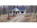 A charming exterior view of a modern home nestled among the trees with a gravel driveway at 330 Fiber Acres A St, Cleveland, NC 27013